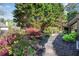 Beautifully landscaped backyard with a stone pathway and lush greenery at 169 Twickenham Trce, Suwanee, GA 30024