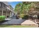 Stone patio and backyard with stairs leading to upper deck offer outdoor entertaining and natural landscape at 169 Twickenham Trce, Suwanee, GA 30024