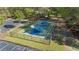 Outdoor community basketball court surrounded by woods and fenced at 169 Twickenham Trce, Suwanee, GA 30024