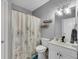 Well-lit bathroom with a floral shower curtain and modern fixtures at 169 Twickenham Trce, Suwanee, GA 30024