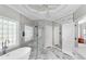 Bright and spacious bathroom featuring a modern tub, glass-enclosed shower, and ample counter space at 169 Twickenham Trce, Suwanee, GA 30024