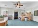 Light-filled room with blue carpet, a ceiling fan, and organized storage at 169 Twickenham Trce, Suwanee, GA 30024
