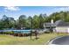 Community pool with a covered pavilion, tables, chairs, and lounge chairs at 169 Twickenham Trce, Suwanee, GA 30024