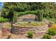 Stone Ascot community sign surrounded by professionally landscaped foliage at 169 Twickenham Trce, Suwanee, GA 30024