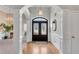Elegant foyer with detailed trim, hardwood floors, and a decorative glass front door at 169 Twickenham Trce, Suwanee, GA 30024