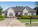 Charming home with a well manicured lawn, mature bushes, neutral colors, and a symmetrical roof line at 169 Twickenham Trce, Suwanee, GA 30024