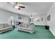 Spacious living room featuring bright green carpet and a view into the kitchen at 169 Twickenham Trce, Suwanee, GA 30024