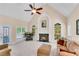 Cozy living room with a fireplace, large windows, and comfortable seating at 169 Twickenham Trce, Suwanee, GA 30024