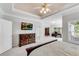 Comfortable main bedroom showcasing a tray ceiling, carpet and separate study area by the window at 169 Twickenham Trce, Suwanee, GA 30024