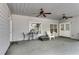 Spacious covered patio features dual ceiling fans, outdoor seating, and natural light for relaxing and entertaining at 169 Twickenham Trce, Suwanee, GA 30024