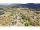 A scenic aerial view of a neighborhood with beautiful homes, green trees, and distant mountains at 65 Indian Springs Ne Dr, Rydal, GA 30171