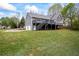 Expansive backyard featuring a tiered deck and two-car garage perfect for outdoor gatherings at 65 Indian Springs Ne Dr, Rydal, GA 30171