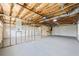 Unfinished basement with exposed ducts, studs, and garage door, offering a blank canvas for customization at 65 Indian Springs Ne Dr, Rydal, GA 30171