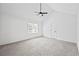 Bright bedroom featuring a vaulted ceiling with fan, neutral walls, and carpet at 65 Indian Springs Ne Dr, Rydal, GA 30171