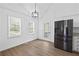Dining area featuring modern lighting and a stainless-steel refrigerator at 65 Indian Springs Ne Dr, Rydal, GA 30171
