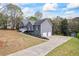 View of the home's exterior with a long driveway and a two-car garage at 65 Indian Springs Ne Dr, Rydal, GA 30171