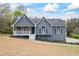 Charming home featuring a stone porch, gray siding, and landscaped front yard at 65 Indian Springs Ne Dr, Rydal, GA 30171