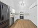 Updated kitchen featuring stainless steel appliances, granite countertops, and white cabinetry at 65 Indian Springs Ne Dr, Rydal, GA 30171