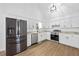 Modern kitchen features stainless appliances, white cabinets, and an eat-in area at 65 Indian Springs Ne Dr, Rydal, GA 30171