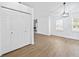 Spacious living room featuring wood floors, large windows, and a walk-in closet at 65 Indian Springs Ne Dr, Rydal, GA 30171