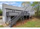 Rear exterior showcasing a large wooden deck and landscaped backyard at 65 Indian Springs Ne Dr, Rydal, GA 30171