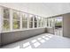 Cozy sunroom with multiple windows, natural light and a door to the deck at 65 Indian Springs Ne Dr, Rydal, GA 30171