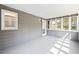 Bright sunroom with many windows, wood paneling, and a door at 65 Indian Springs Ne Dr, Rydal, GA 30171