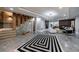 Finished basement with a staircase, statement rug, and open concept living area at 9105 Old Southwick Pass, Johns Creek, GA 30022