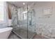 This bathroom features a luxurious tub, large glass shower, and marble accents for a spa-like experience at 9105 Old Southwick Pass, Johns Creek, GA 30022