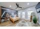 Modern bedroom featuring light wood floors, decorative walls and a ceiling fan at 9105 Old Southwick Pass, Johns Creek, GA 30022