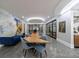 Spacious dining area with a large table, modern chairs, and a custom wine cellar at 9105 Old Southwick Pass, Johns Creek, GA 30022