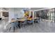 Contemporary dining room with wooden table, gray chairs, and wine cellar showcasing stylish modern design elements at 9105 Old Southwick Pass, Johns Creek, GA 30022