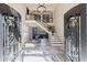 Grand foyer with marble floors, staircase, chandelier, and a view to the living area at 9105 Old Southwick Pass, Johns Creek, GA 30022