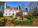 Beautiful home exterior with manicured landscaping and circular driveway at 9105 Old Southwick Pass, Johns Creek, GA 30022