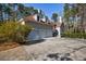 Home exterior featuring a large three car garage and paved drive at 9105 Old Southwick Pass, Johns Creek, GA 30022