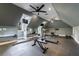 Spacious home gym with various exercise equipment and multiple ceiling fans at 9105 Old Southwick Pass, Johns Creek, GA 30022