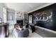 Stylish home office with black accent wall, fireplace, gray walls, and two armchairs at 9105 Old Southwick Pass, Johns Creek, GA 30022