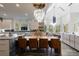 Open-concept kitchen and dining area with large island, modern lighting, and stainless steel appliances at 9105 Old Southwick Pass, Johns Creek, GA 30022