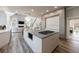 Bright kitchen features modern cabinetry, stainless steel appliances, a large island with gas cooktop and adjacent living area at 9105 Old Southwick Pass, Johns Creek, GA 30022