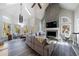 Bright living room features vaulted ceilings, multiple windows, fireplace and hardwood floors at 9105 Old Southwick Pass, Johns Creek, GA 30022