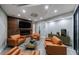 Cozy living room with leather sofas, a fireplace, and a modern TV, creating a comfortable space at 9105 Old Southwick Pass, Johns Creek, GA 30022