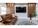 Media room with a large television, comfortable reclining sofa, and decorative paneling at 9105 Old Southwick Pass, Johns Creek, GA 30022