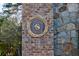 Close up of stone and brick community signage with a logo at 9105 Old Southwick Pass, Johns Creek, GA 30022