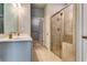 Bathroom with double sinks, tiled shower, and sleek design at 3875 Shelleydale Dr, Powder Springs, GA 30127