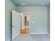 A room with an open door leading to the kitchen at 3875 Shelleydale Dr, Powder Springs, GA 30127