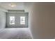 Spacious bedroom featuring natural light, neutral paint, and modern tray ceiling at 3875 Shelleydale Dr, Powder Springs, GA 30127