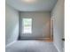 Cozy bedroom with neutral paint, plush carpet, and natural light at 3875 Shelleydale Dr, Powder Springs, GA 30127