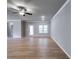 Open living room with fan, neutral paint, crown molding, and patio door with access to backyard at 3875 Shelleydale Dr, Powder Springs, GA 30127