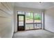 Sunroom patio with white shiplap walls and a view of the fenced-in backyard at 3875 Shelleydale Dr, Powder Springs, GA 30127