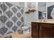 Well-lit bathroom featuring a vanity, toilet, and shower with a decorative black and white curtain at 4745 Prather Farm Cir, Cumming, GA 30040